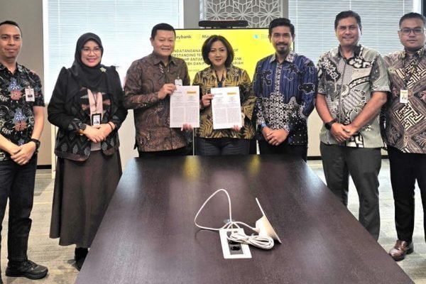 Direktur Pembiayaan Bank NTB Syariah, Agus Suhendro bersama perwakilan Maybank Indonesia menunjukkan dokumen Nota Kesepahaman kemitraan strategis untuk memperkuat layanan pembiayaan dan remitansi bagi PMI di Jakarta, Rabu (9/9/2026). (Foto: Dok. Bank NTB Syariah)