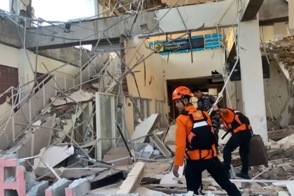 Petugas melakukan penanganan di tengah bangunan yang rusak akibat gempa M7,7 di Nusa Tenggara Timur, Sabtu (15/8/2026).