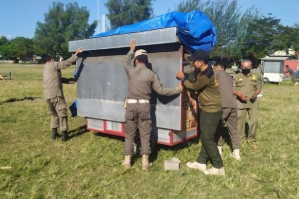 Anggota Pol PP Lombok Utara saat melakukan penertiban pedagang di area lapangan Tanjung. (Foto. kicknews.today/Ist)