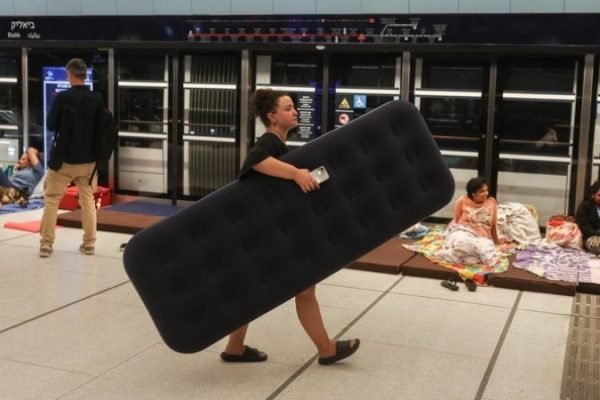 Di sekitar metropolitan Tel Aviv, pusat komersial Israel, beberapa orang telah mencari keselamatan di stasiun kereta bawah tanah. Foto: REUTERS/Ronen Zvulun